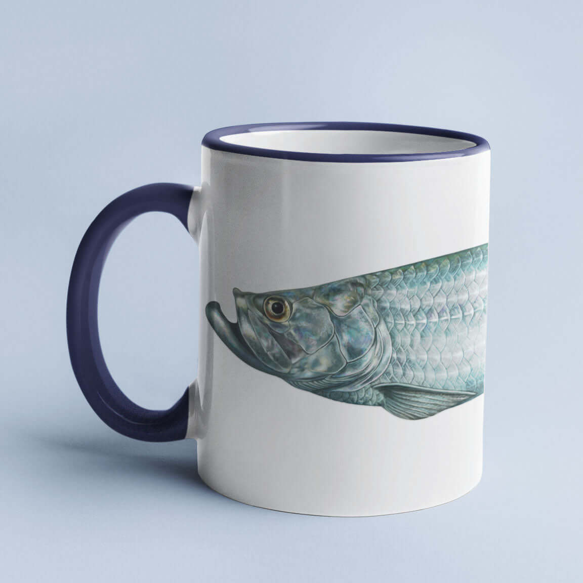 Ceramic mug with a blue handle featuring a detailed fish illustration on a light blue background.