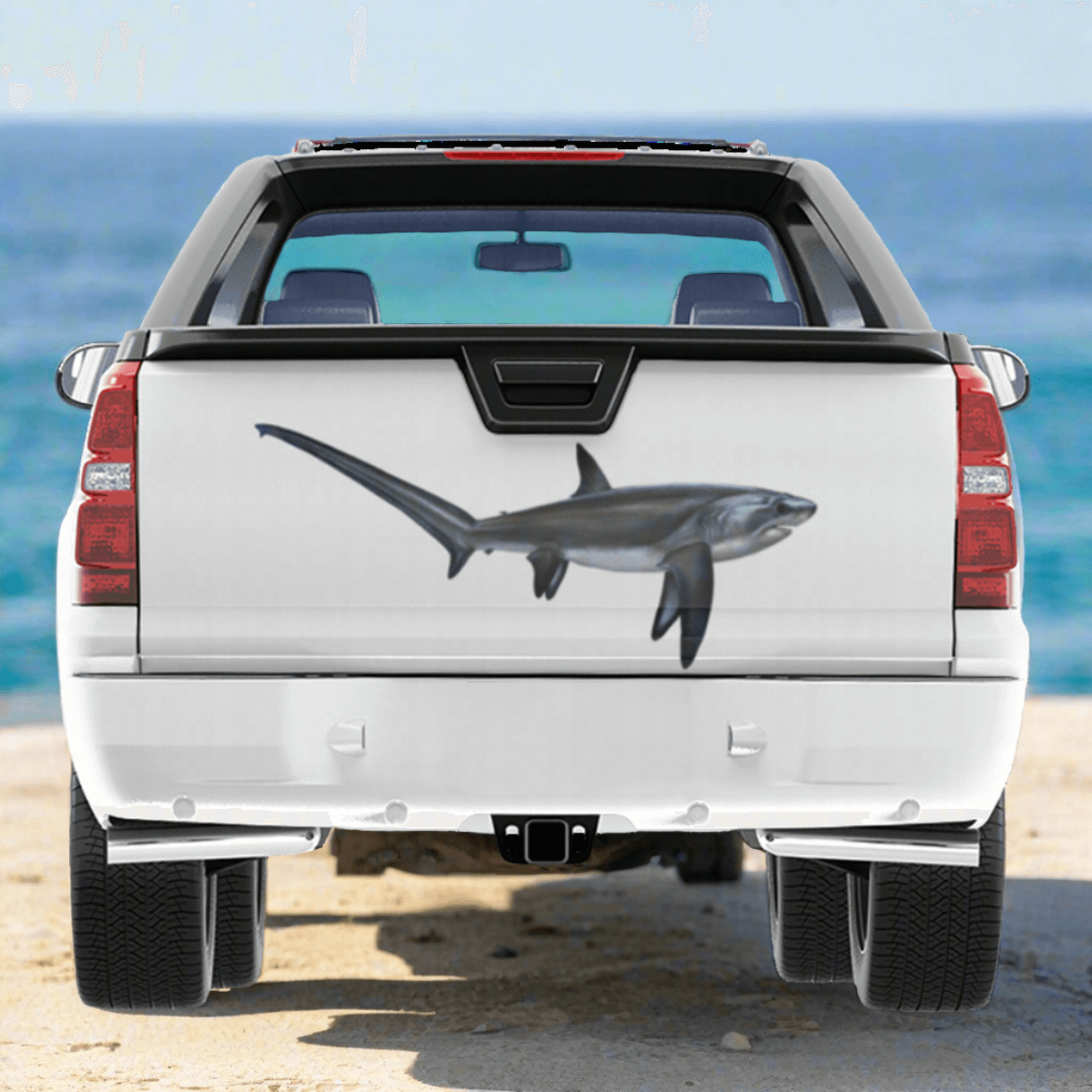 Thresher Shark large decal on a pickup truck by a blue ocean.