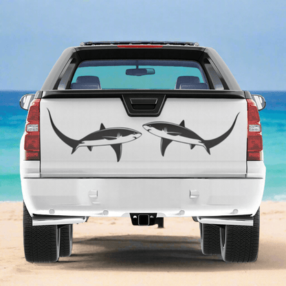 Large Thresher Shark decals on a pickup truck near the ocean.