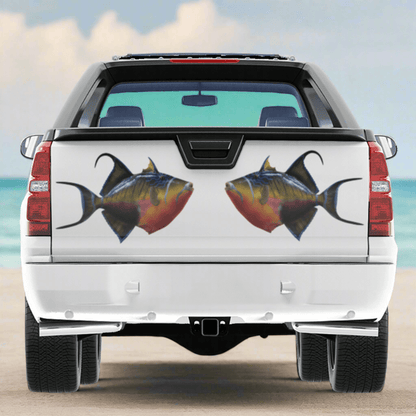 Triggerfish large decals on a pickup truck near the ocean.