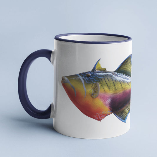 Triggerfish accent mug with dark blue handle on light blue background.