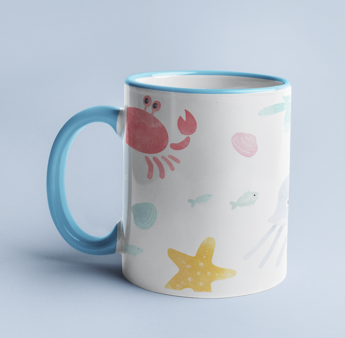 Watercolor Sea Creatures mug on a light blue background, with a light blue handle and rim.