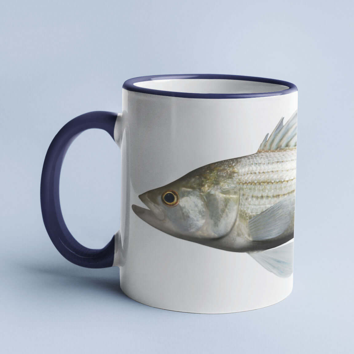 White ceramic mug with a blue handle, featuring a detailed fish graphic design.