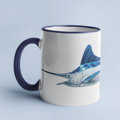 White Marlin accent mug with dark blue handle on light blue background.