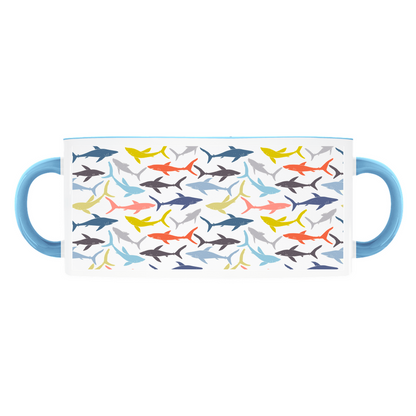 Colorful Reef Sharks Pattern mug on a light blue background, with a dark blue handle and rim.