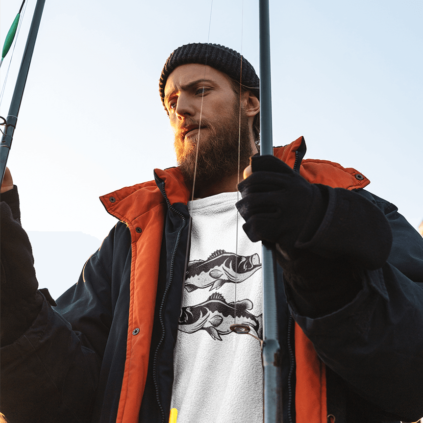 Man wearing Largemouth Bass T-Shirt holding fishing rods, showcasing black and white fish design.