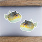 Pufferfish stickers on a laptop.