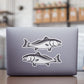 Red Drum Redfish stickers on a laptop.