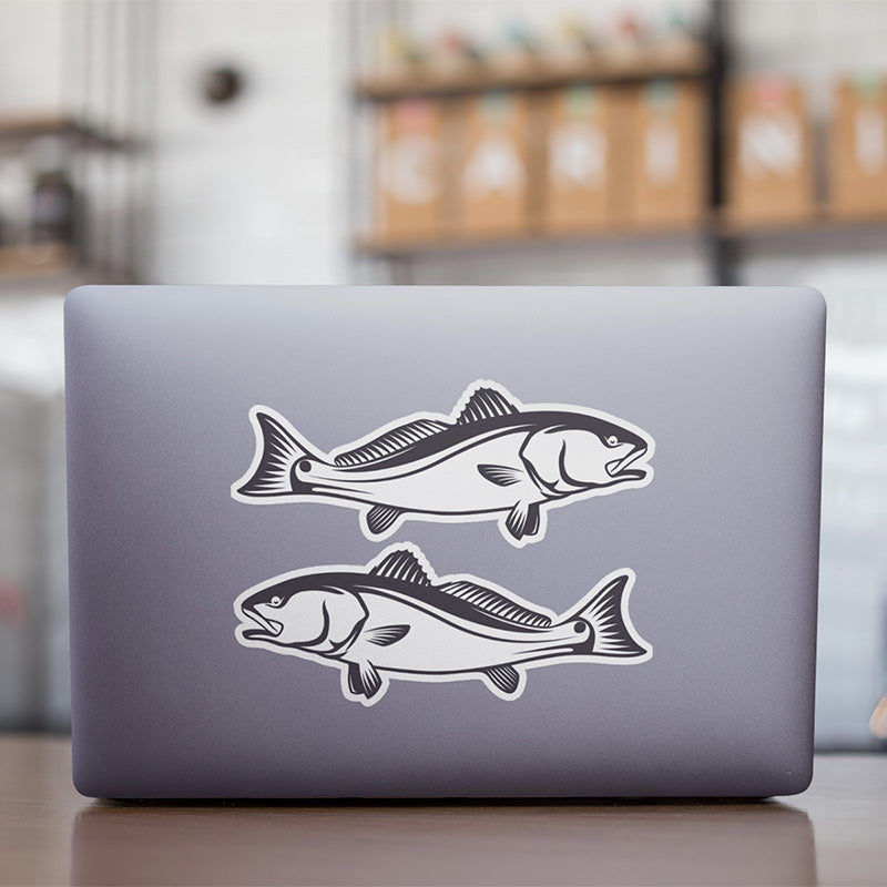 Red Drum Redfish stickers on a laptop.