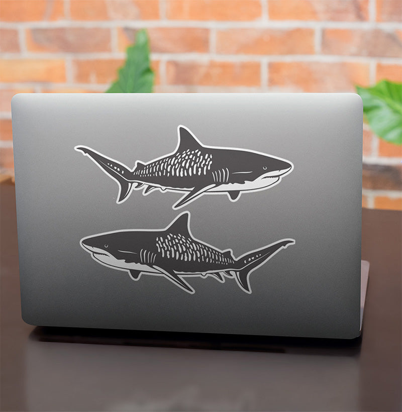 Tiger Shark stickers on a laptop.