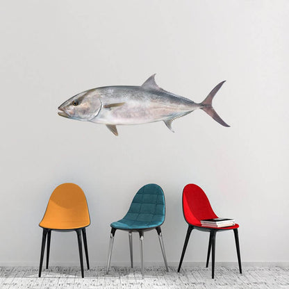 Large fish wall decal above colorful chairs in modern room.