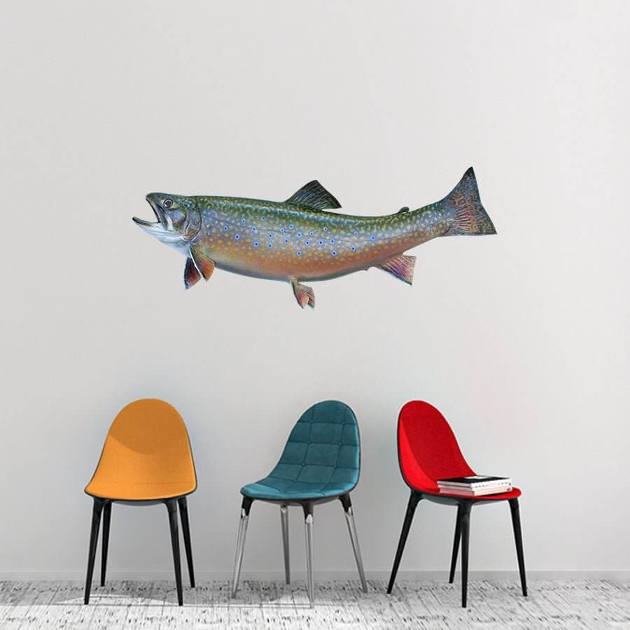 Brook Trout fish wall decal displayed on a white wall above three colorful chairs.